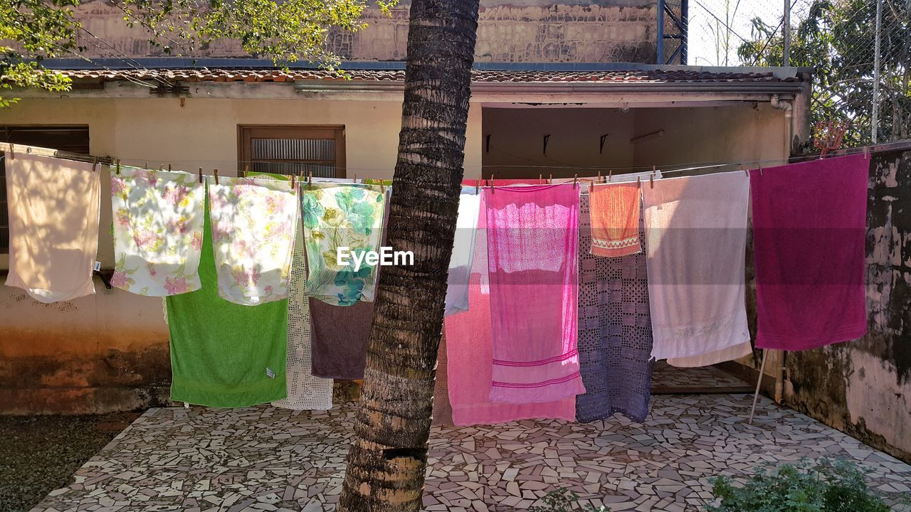 CLOTHES DRYING AGAINST BUILT STRUCTURE