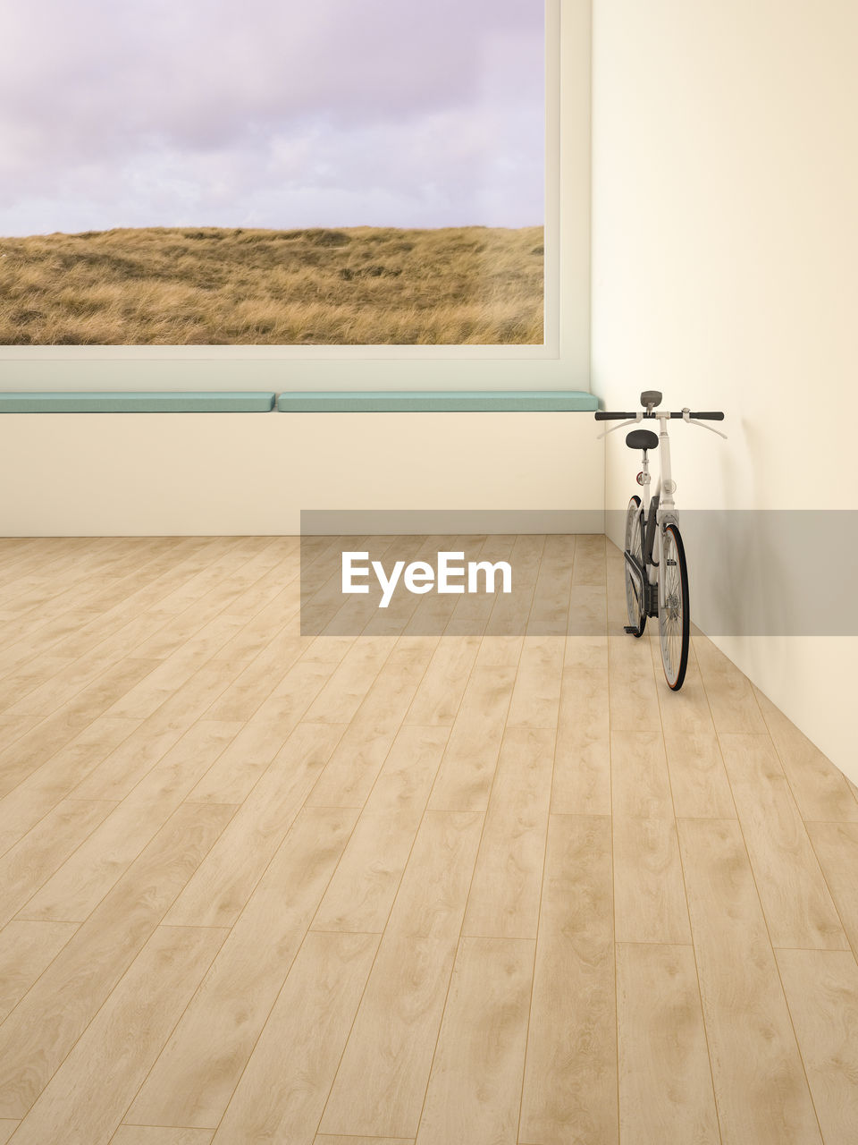 Electric bicycle in room, view through window to dunes