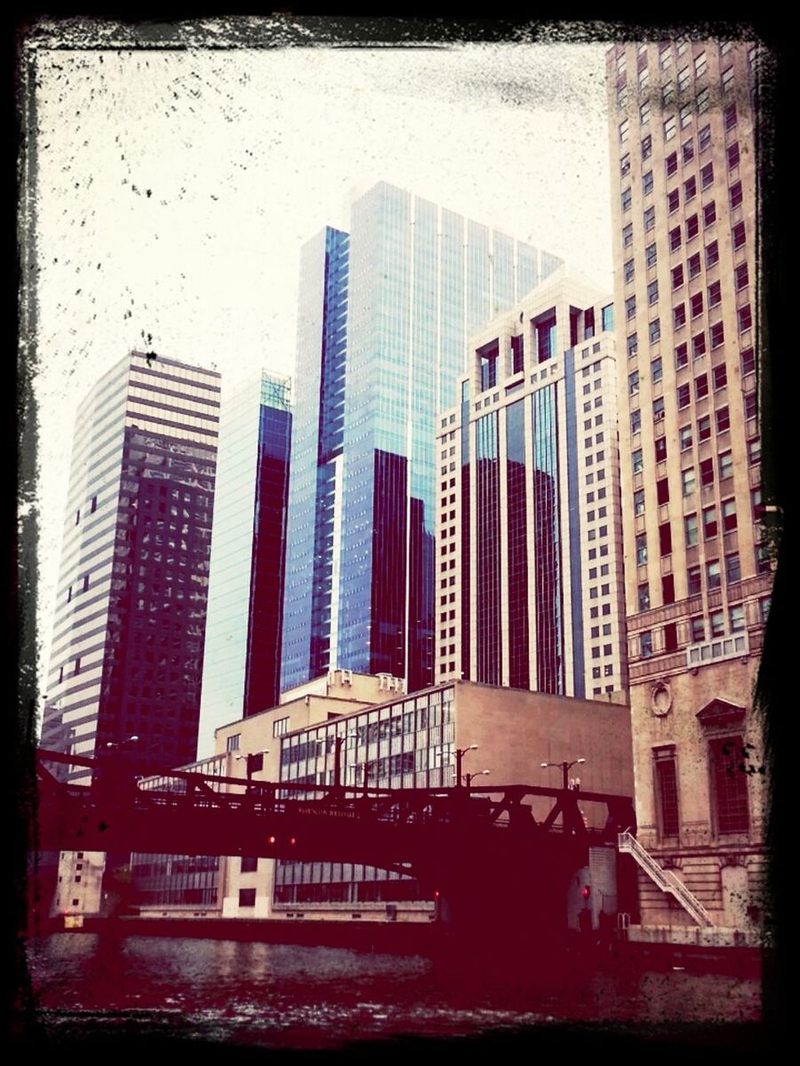 View of bridge over river against buildings