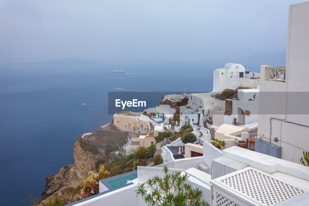 Panorama of houses in the village of oia and the caldera on a rare rainy day, santorini, greece