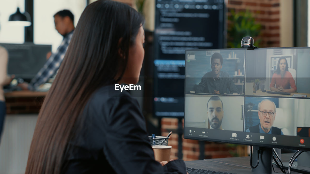 Computer programmer talking on video conference