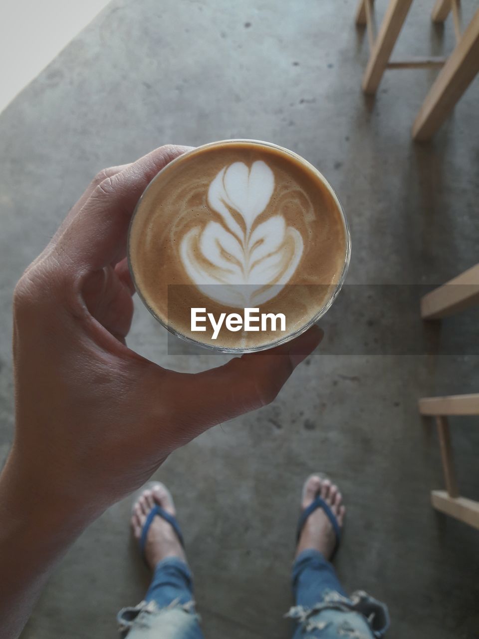 Low section of person holding coffee cup