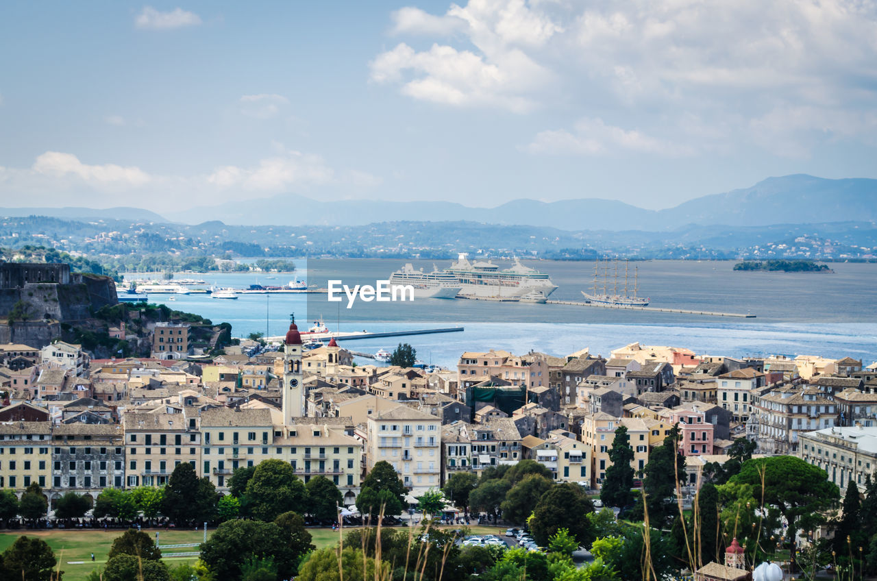 High angle view of buildings by sea against sky