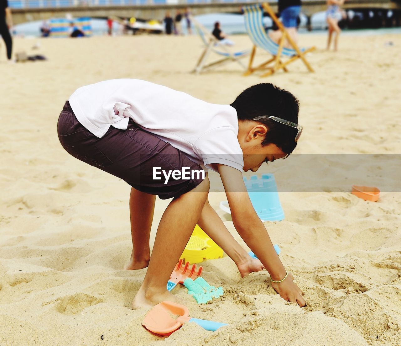 Side view of boy playing at beach