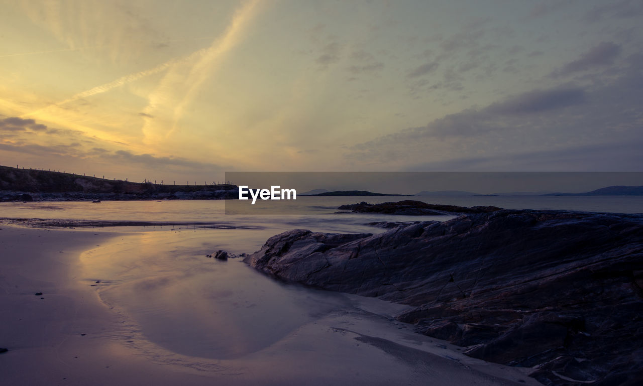 Scenic view of snow covered landscape against sky during sunset