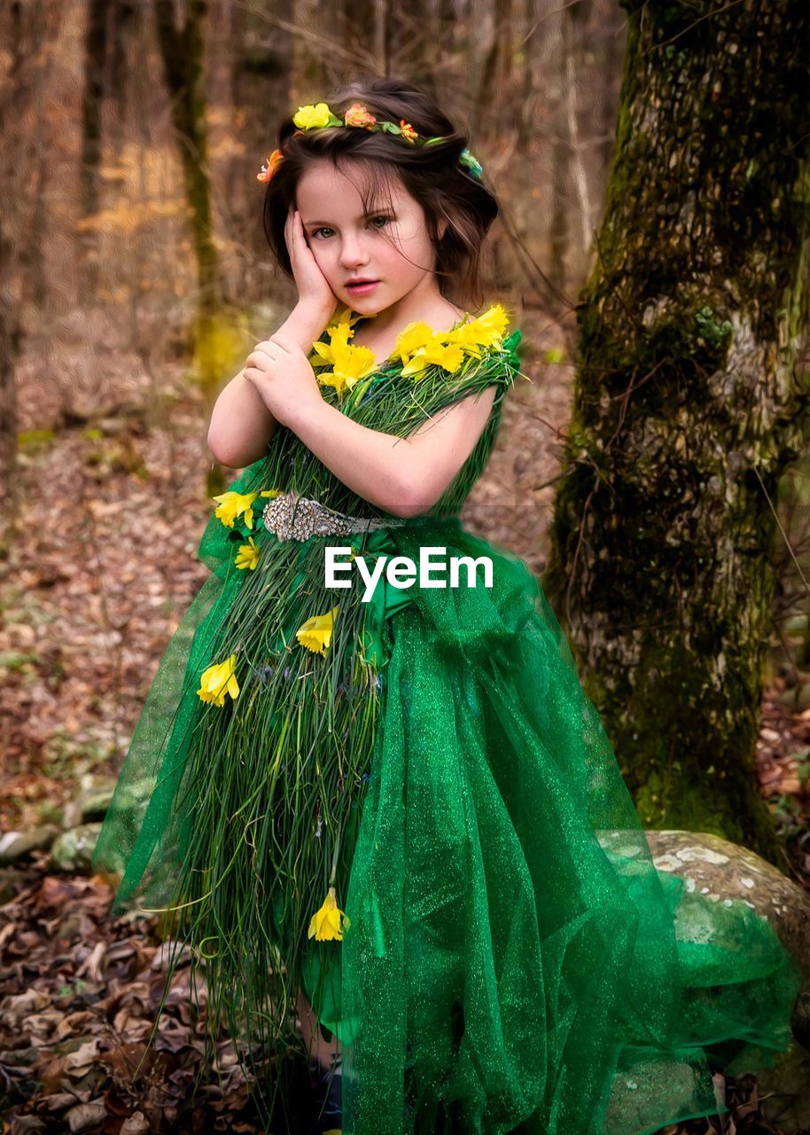 PORTRAIT OF A CUTE GIRL STANDING ON A LAND