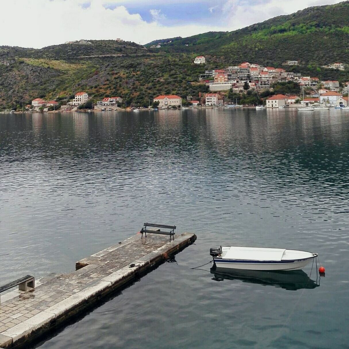 Boat moored at pier in lake