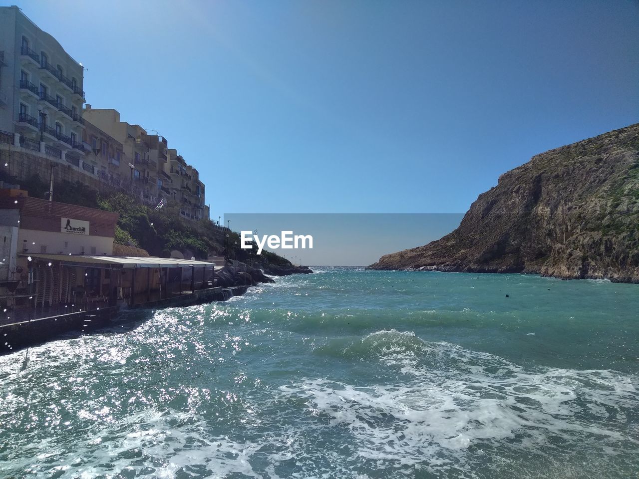 Scenic view of sea against clear blue sky