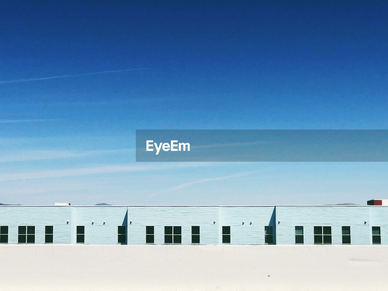 Scenic view of a building against clear blue sky