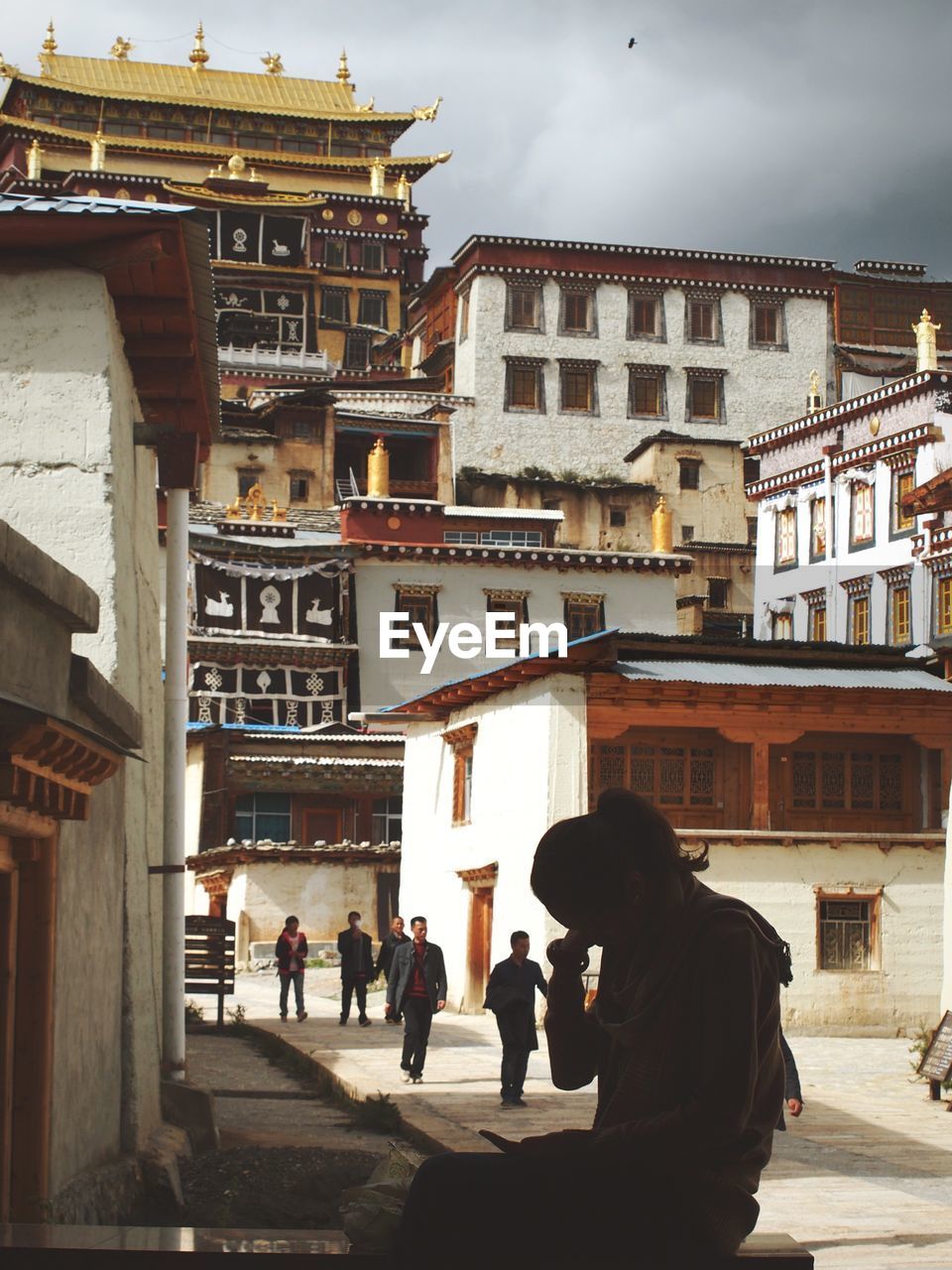 People walking on street amidst buildings