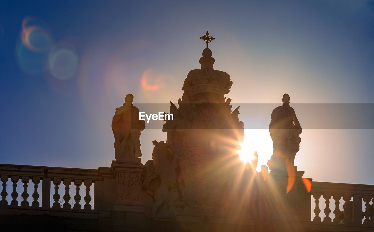 low angle view of statue against sky during sunset