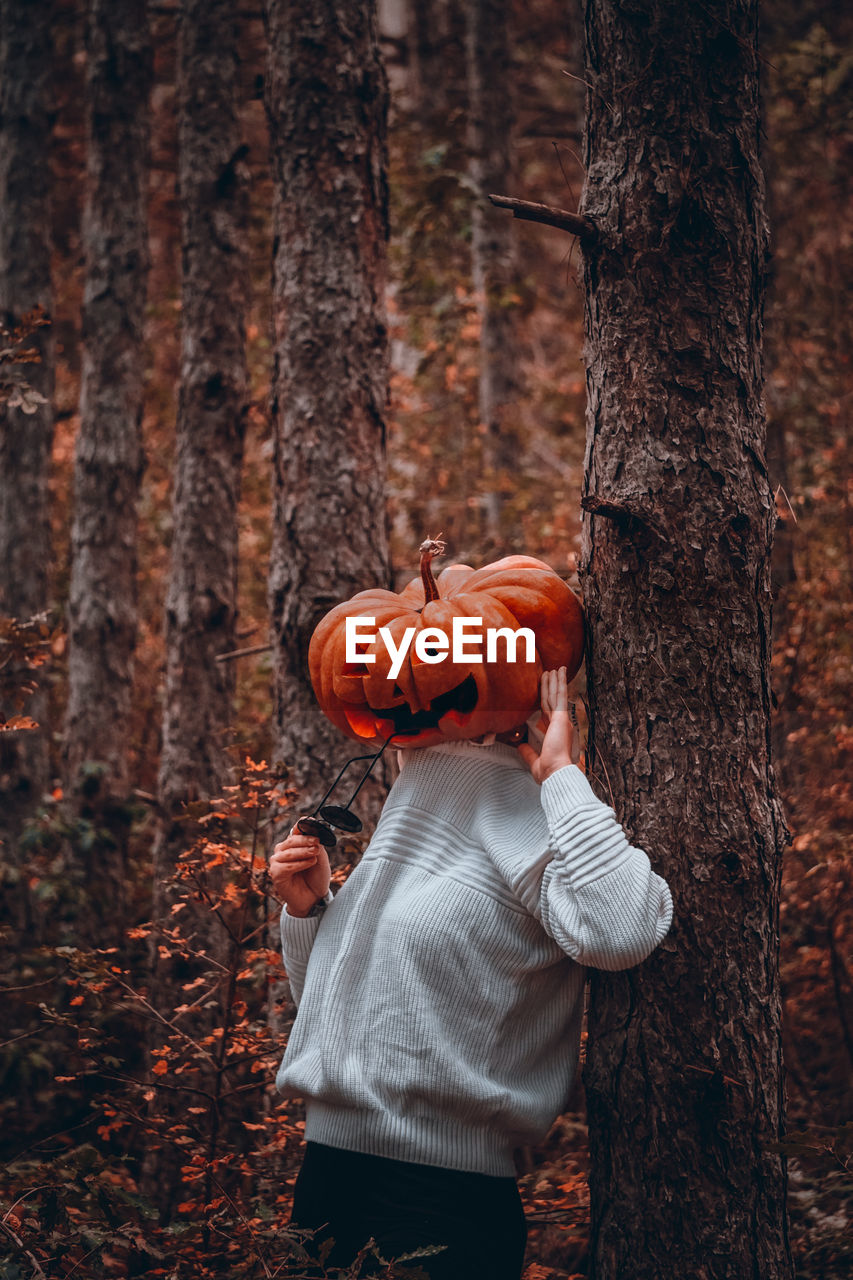 Full length of a boy in a forest in hallowween with sunglasses