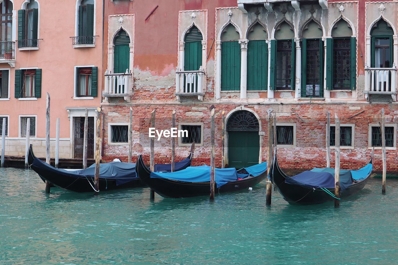 gondola, nautical vessel, canal, water, transportation, mode of transportation, boat, travel destinations, travel, architecture, gondolier, tourism, vehicle, building exterior, romance, watercraft, built structure, love, nature, moored, city, trip, holiday, lagoon, vacation, tourist, sea, window, boating, outdoors, waterfront, day, waterway, building, beauty in nature, wooden post