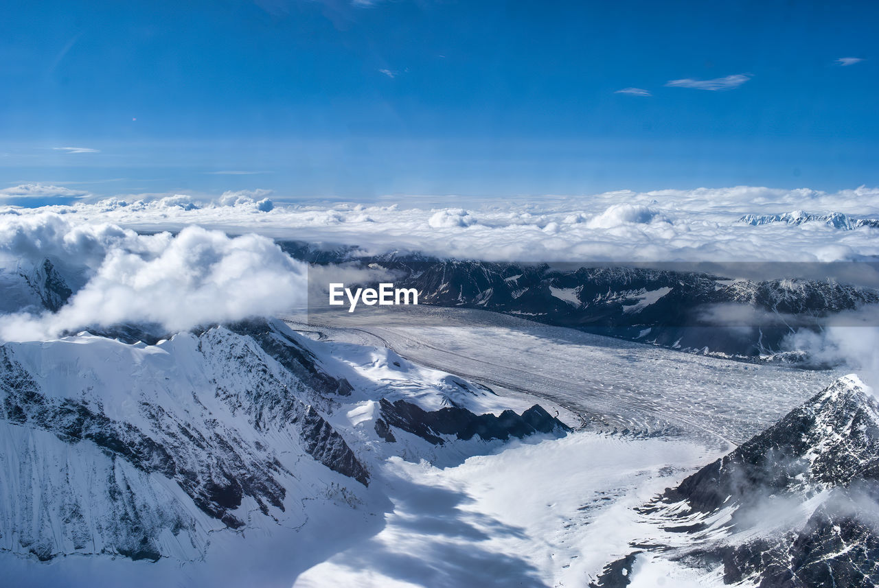 Aerial view of snowcapped mountains against sky