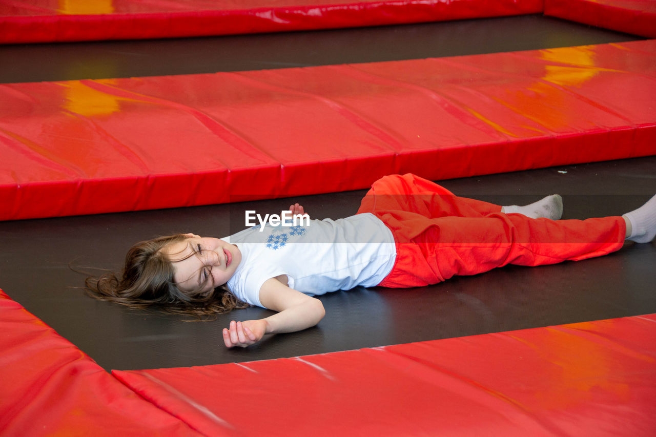 Happy lsports girl having fun while jumping on trampoline