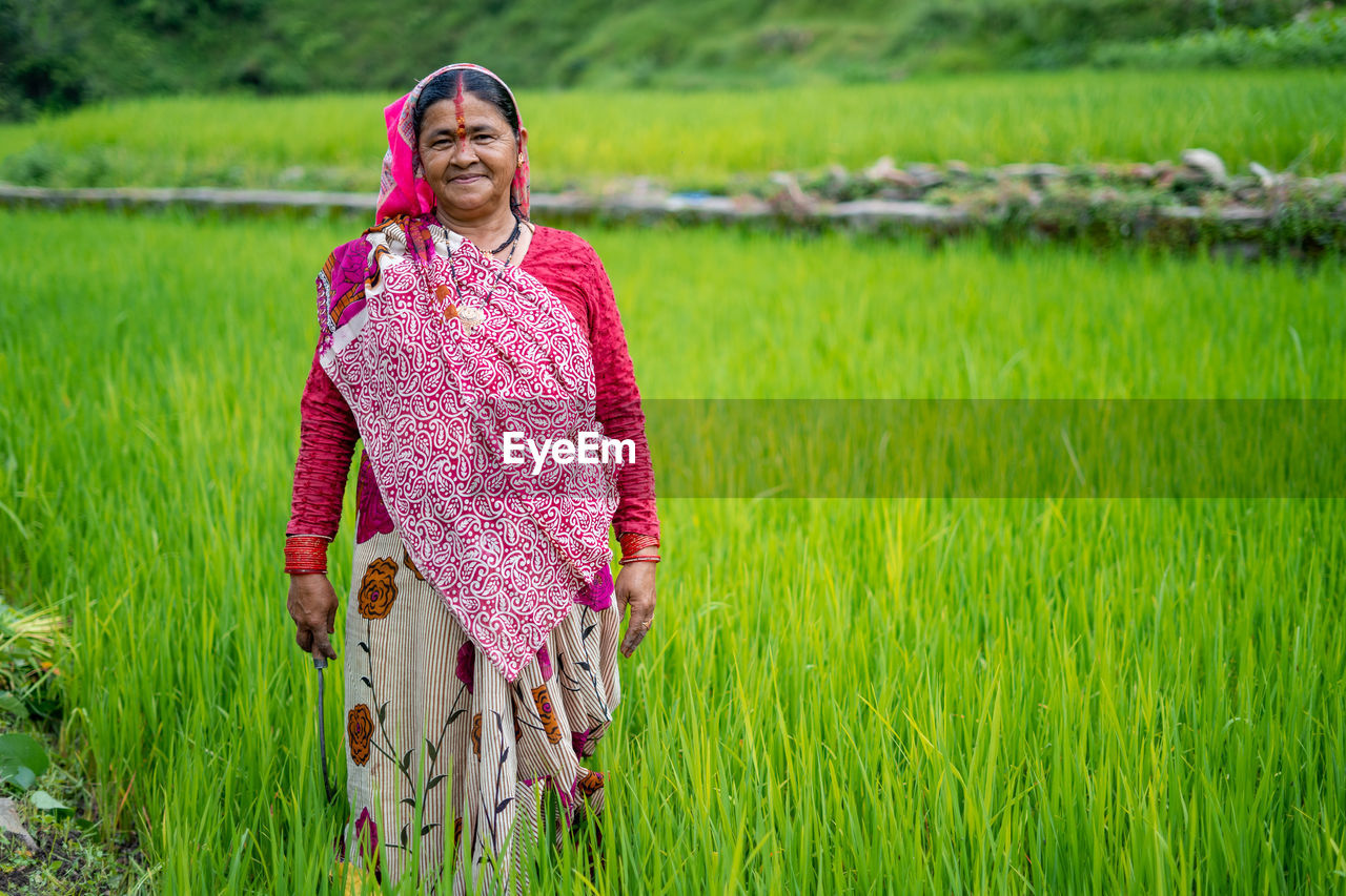 Portrait of mature woman standing at farm