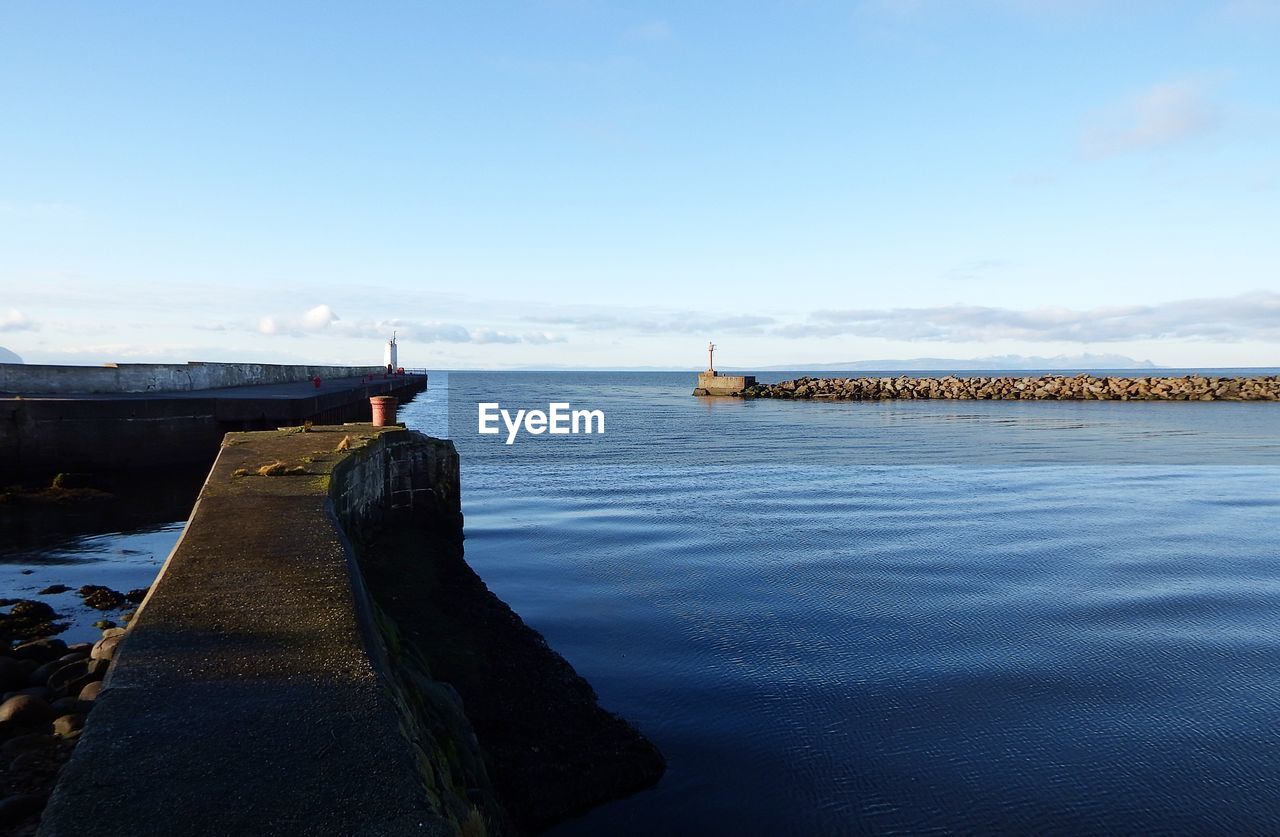 PIER BY SEA AGAINST BLUE SKY