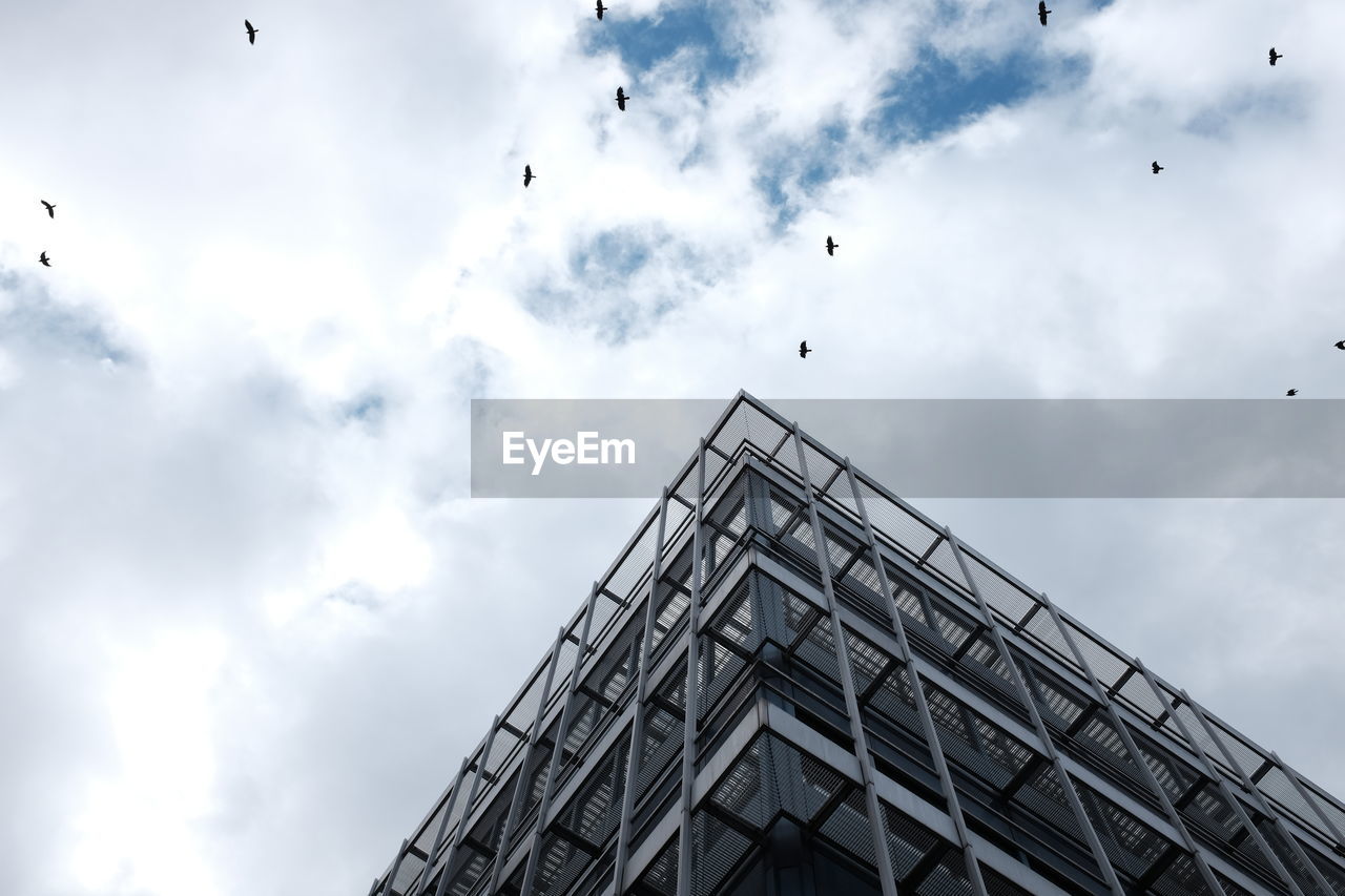 Low angle view of building against cloudy sky