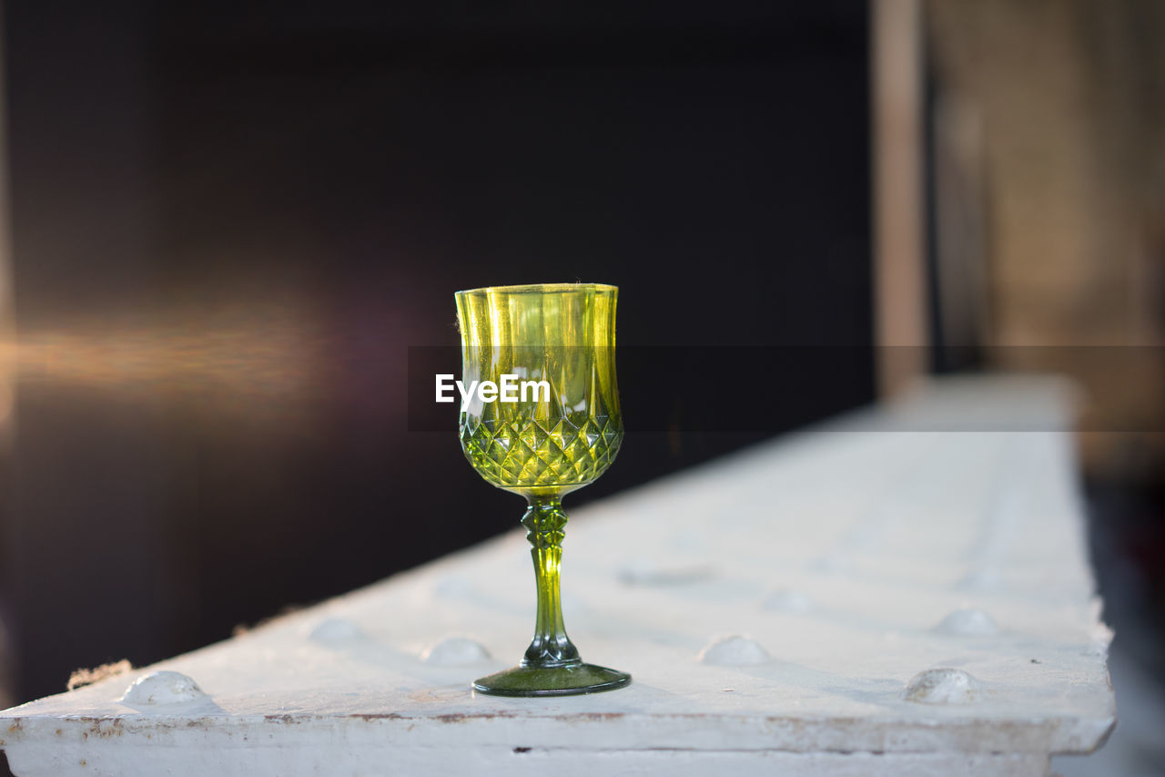 High angle view of empty crystal wineglass on wall