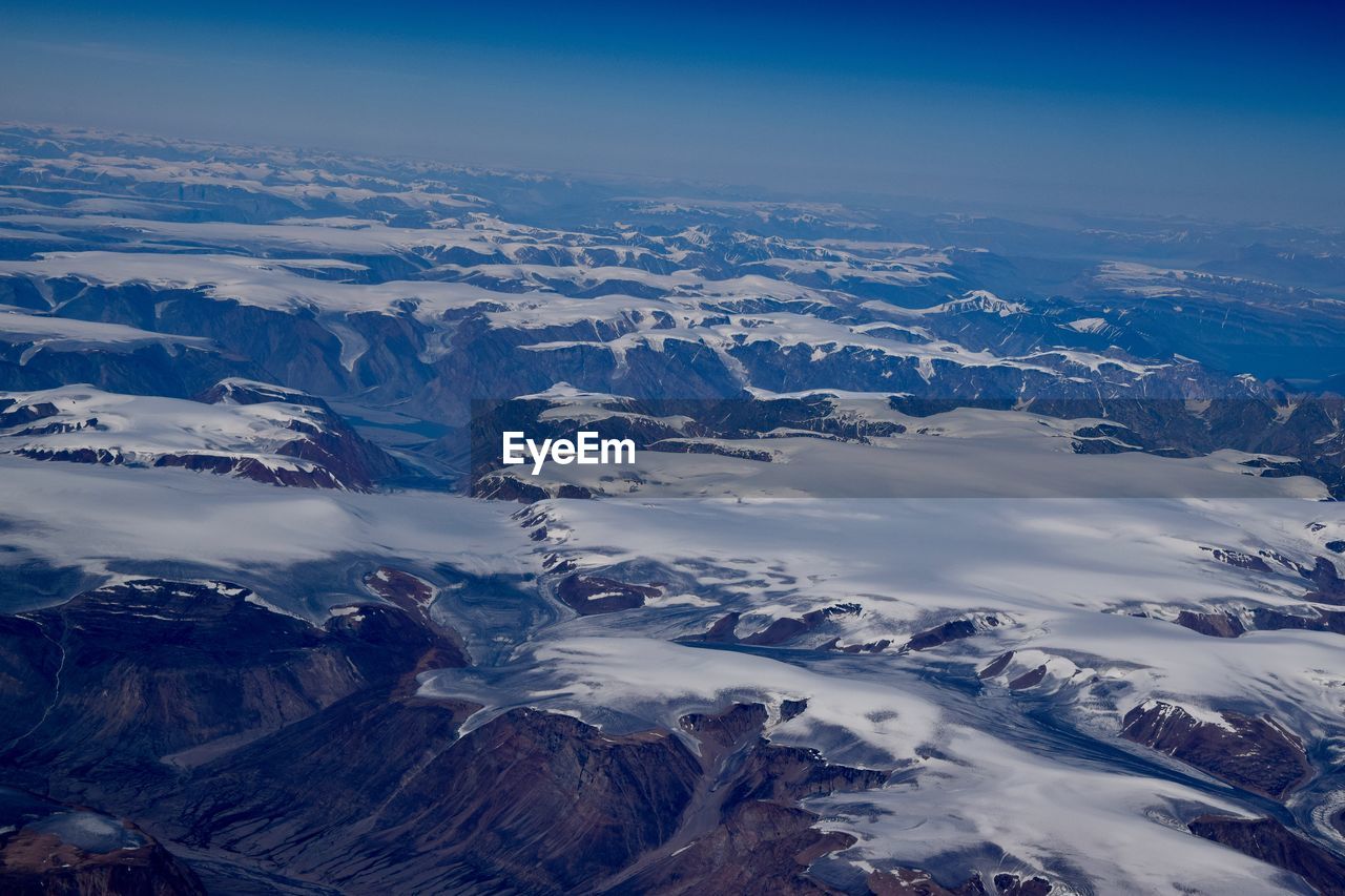 Aerial view of snowcapped mountains against sky