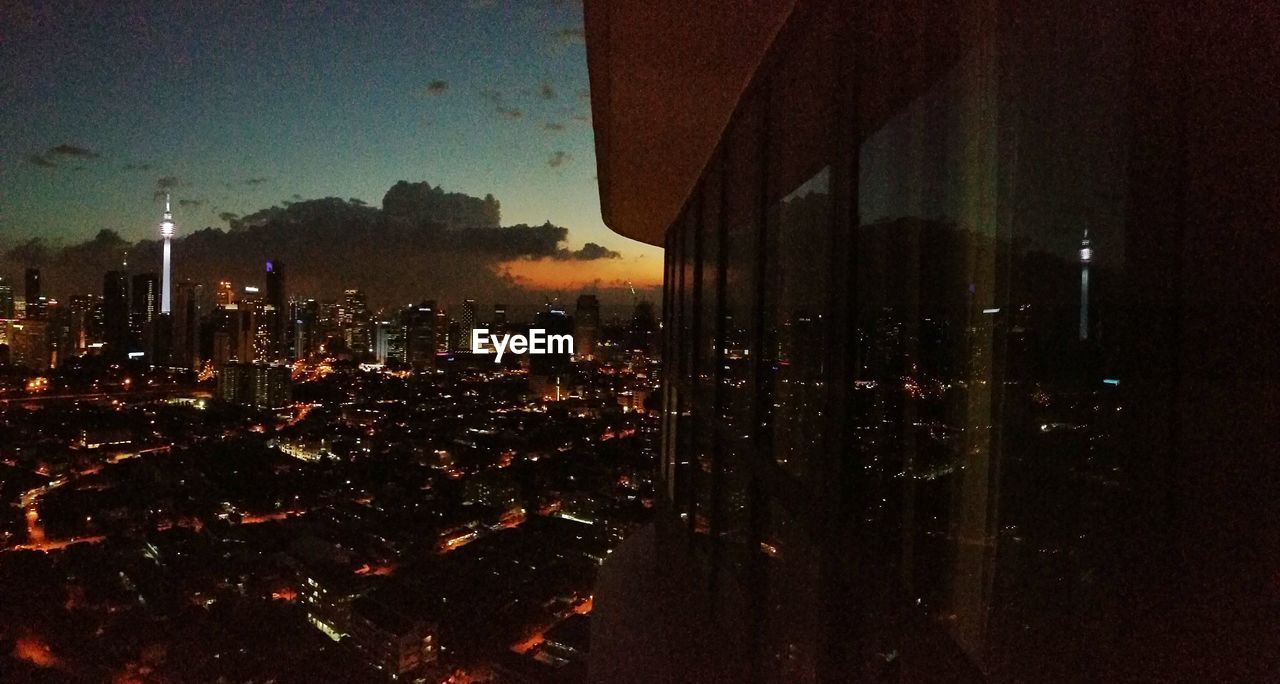 VIEW OF ILLUMINATED CITYSCAPE AT NIGHT