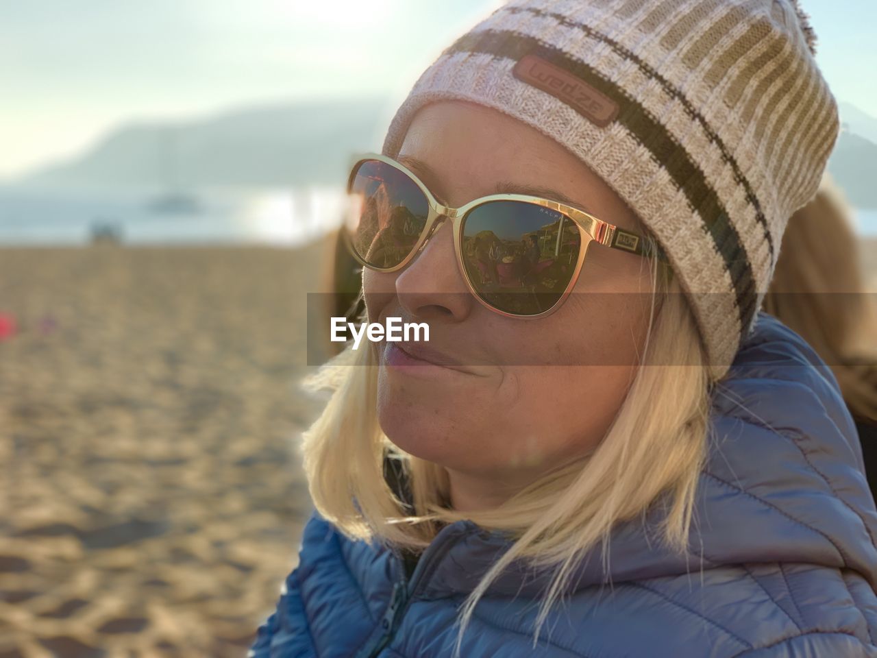 Close-up of woman wearing sunglasses at beach