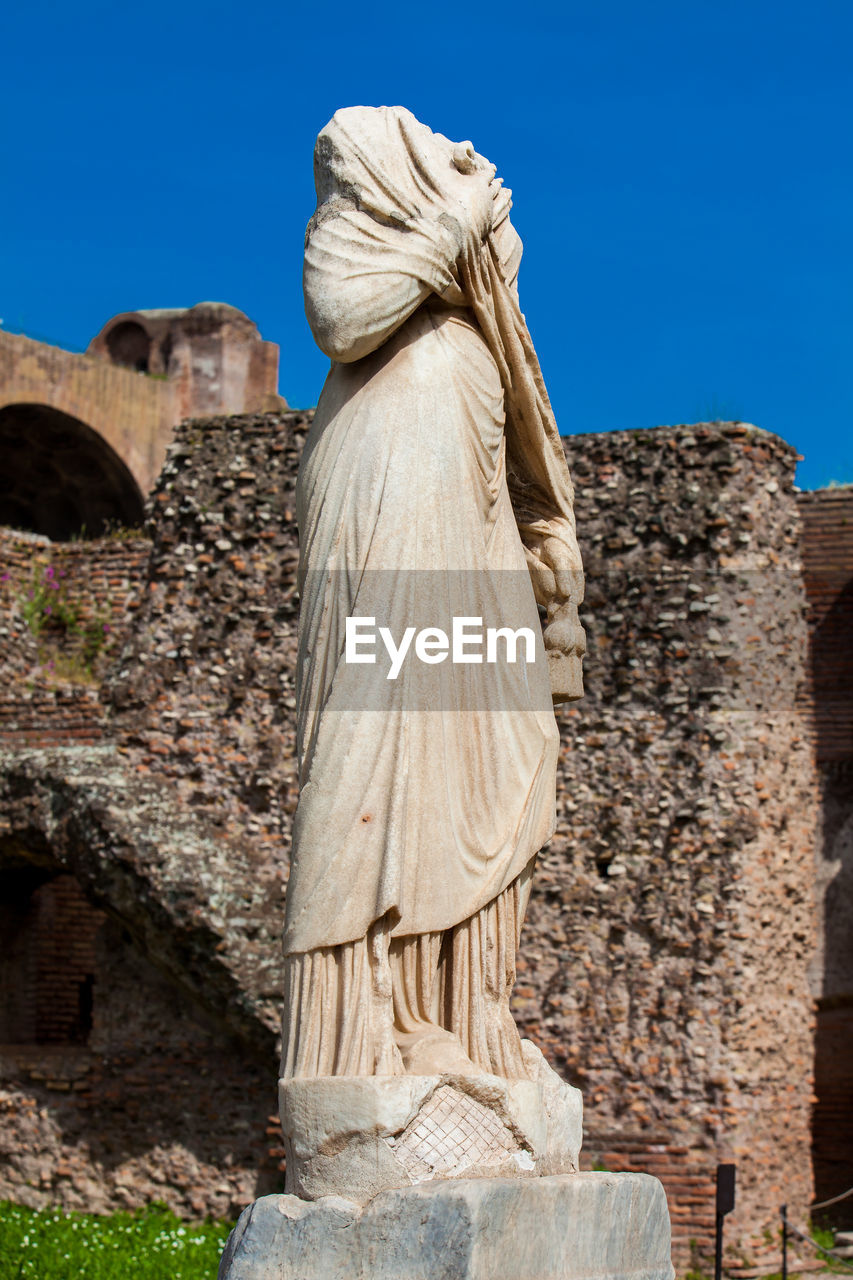 STATUE AGAINST CLEAR SKY