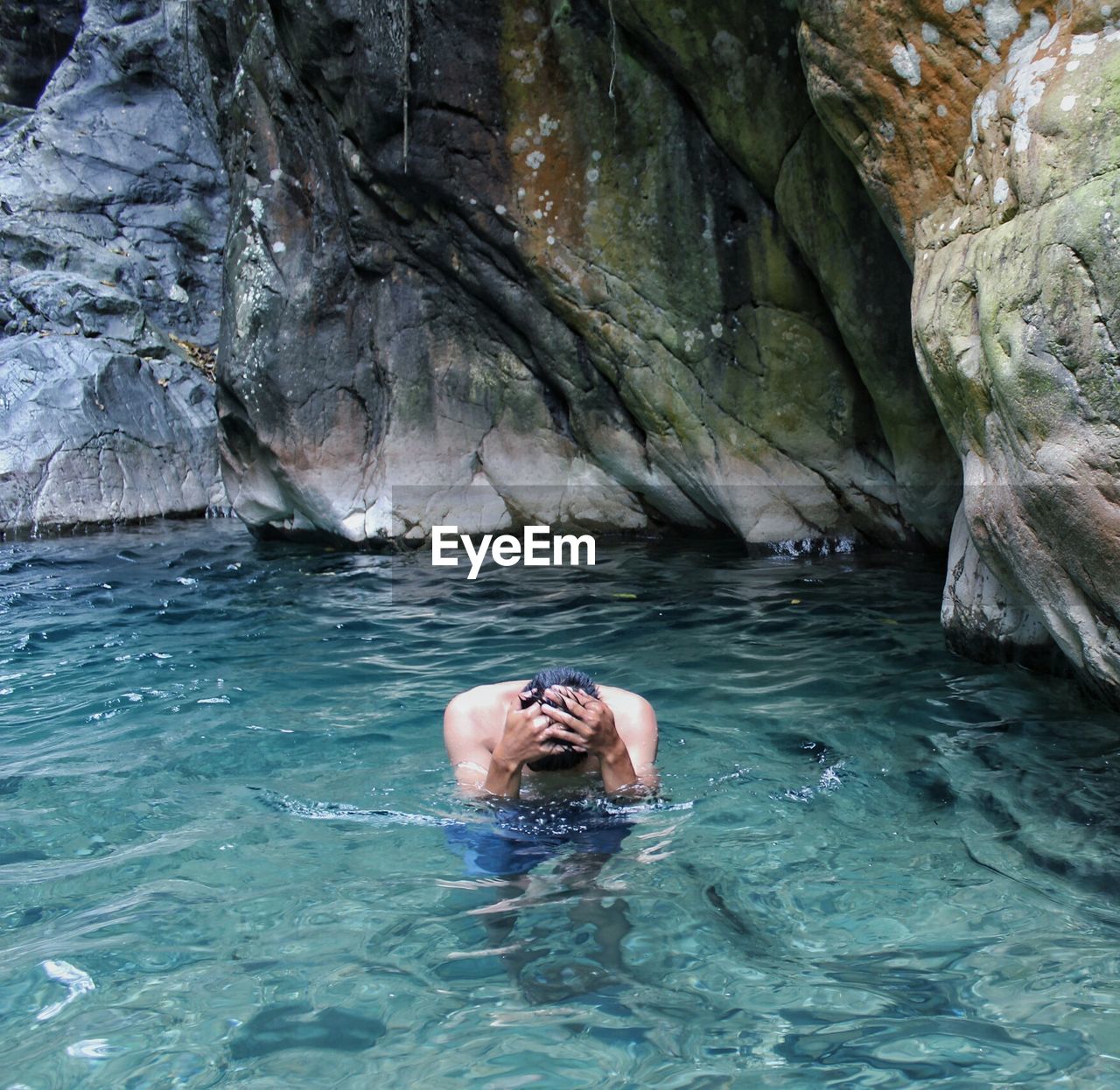 High angle view of mid adult man swimming in sea