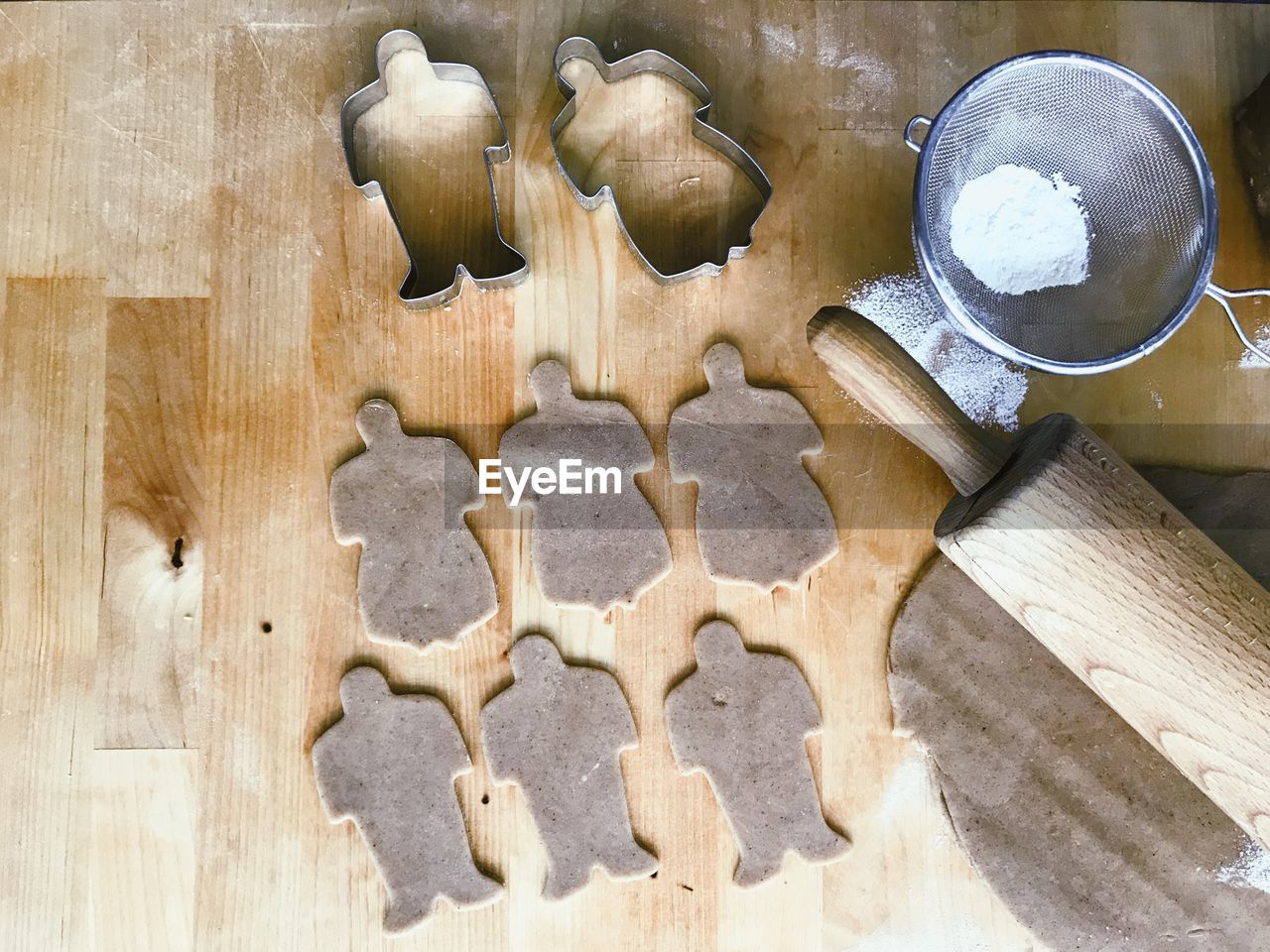 High angle view of cookies and pastry cutter on table