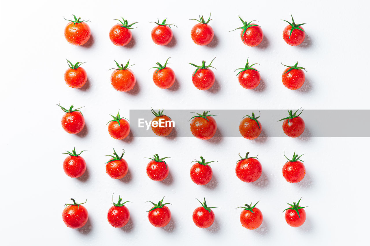 red, food and drink, food, healthy eating, fruit, plant, wellbeing, freshness, studio shot, vegetable, tomato, produce, no people, large group of objects, indoors, in a row, berry, arrangement, petal, white background, directly above, high angle view, cherry tomato, still life, vitamin, organic