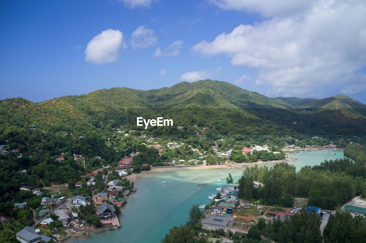 Drone field of view of turquoise blue water and harbour in praslin, seychelles.