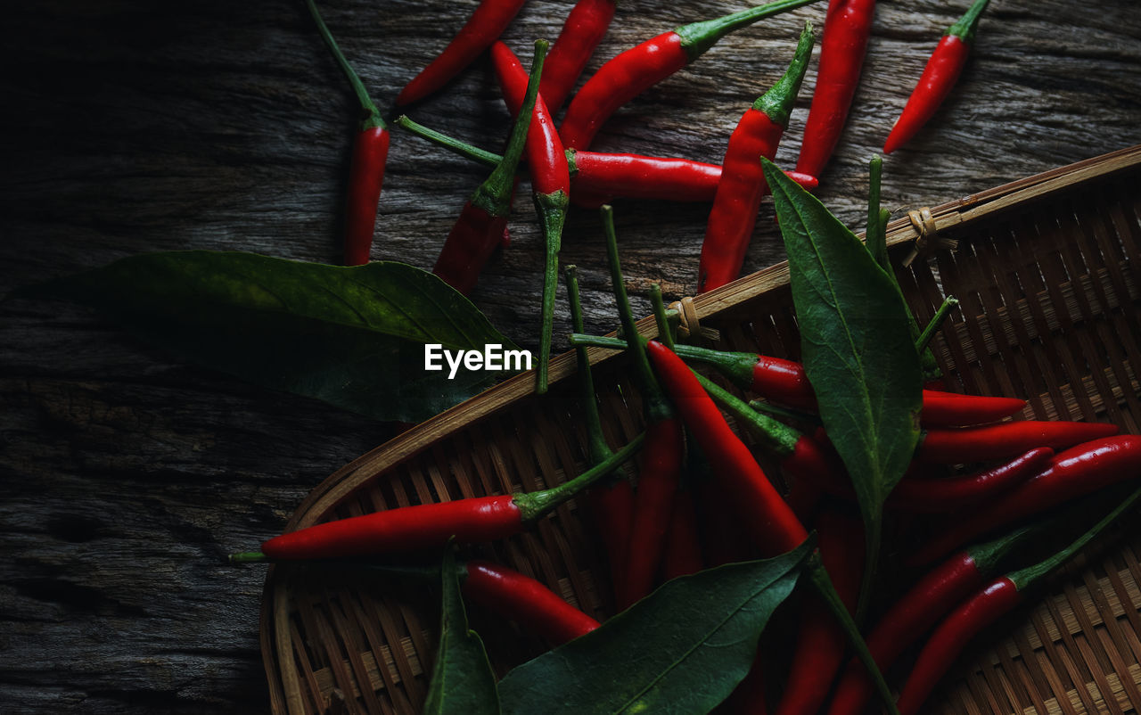 Red ripe chili pepper on the wicker basket 