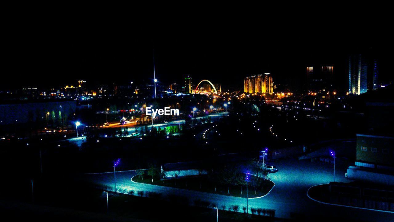 VIEW OF ILLUMINATED CITYSCAPE AT NIGHT