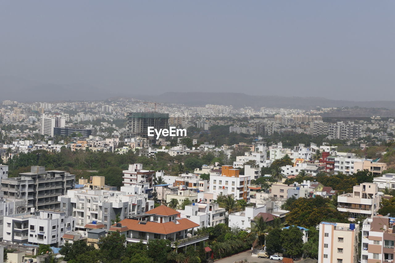 HIGH ANGLE SHOT OF TOWNSCAPE AGAINST SKY