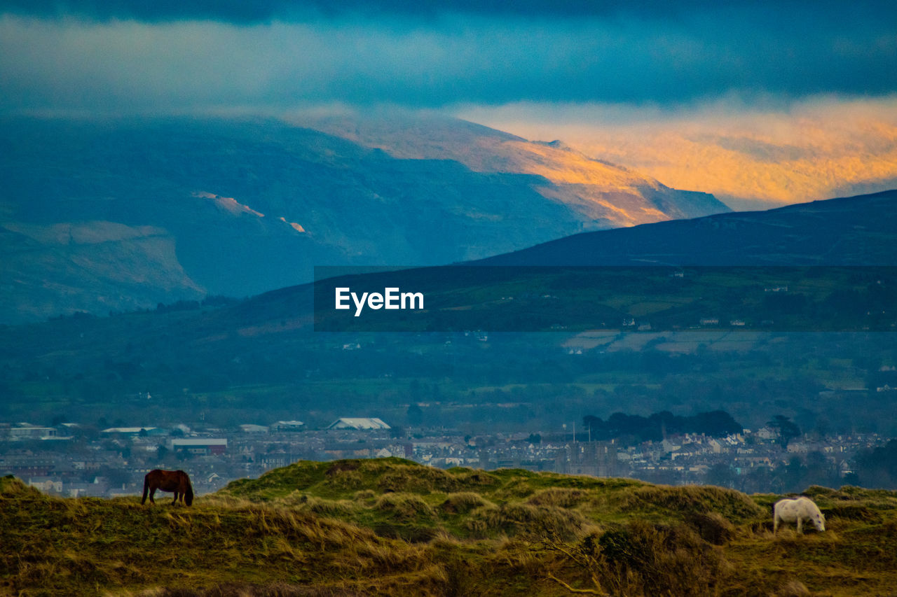 scenic view of mountains against sky during sunset