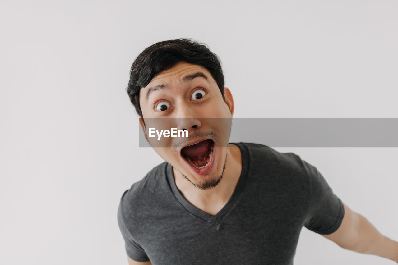 portrait of smiling young man against white background