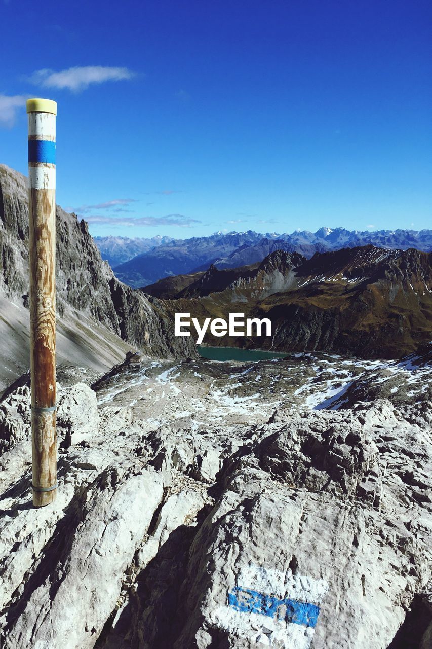 Scenic view of mountains against blue sky