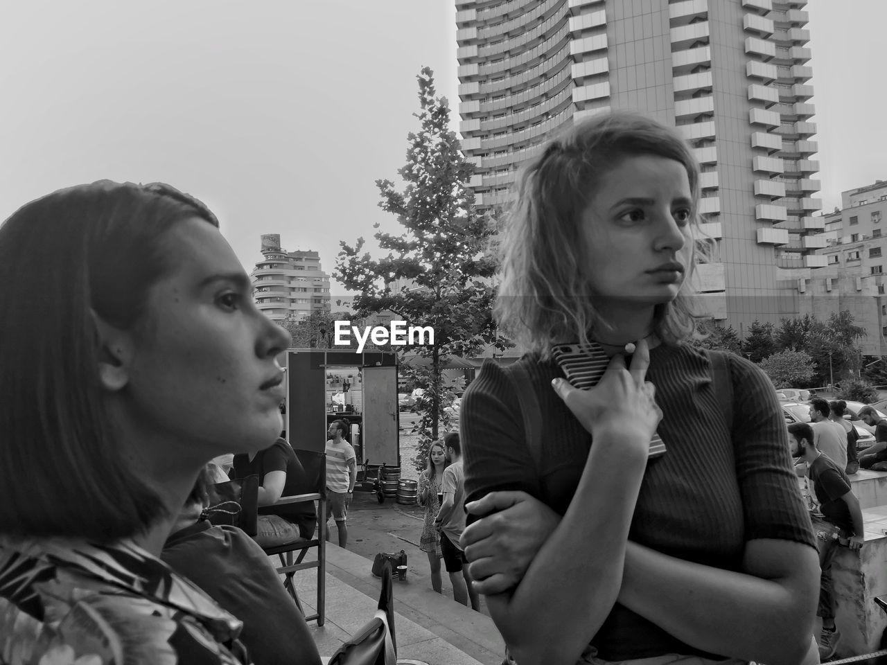 Women looking away against buildings in city