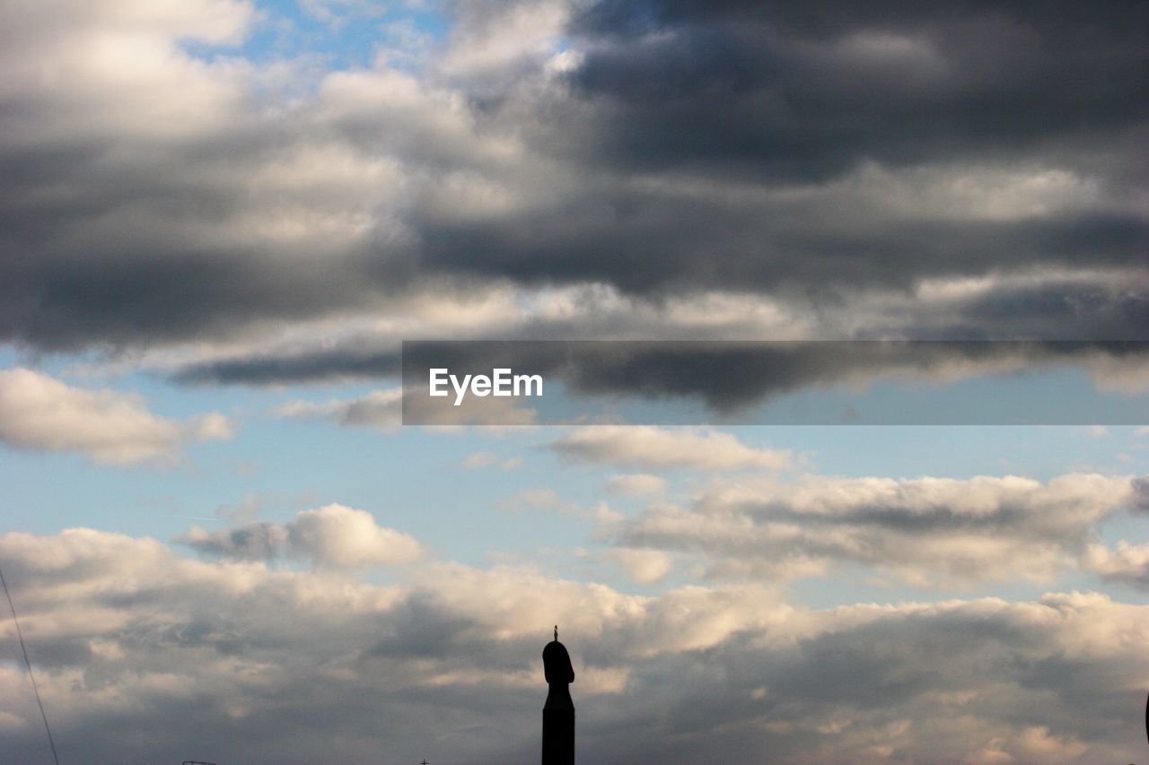 SILHOUETTE OF BIRD AGAINST CLOUDY SKY