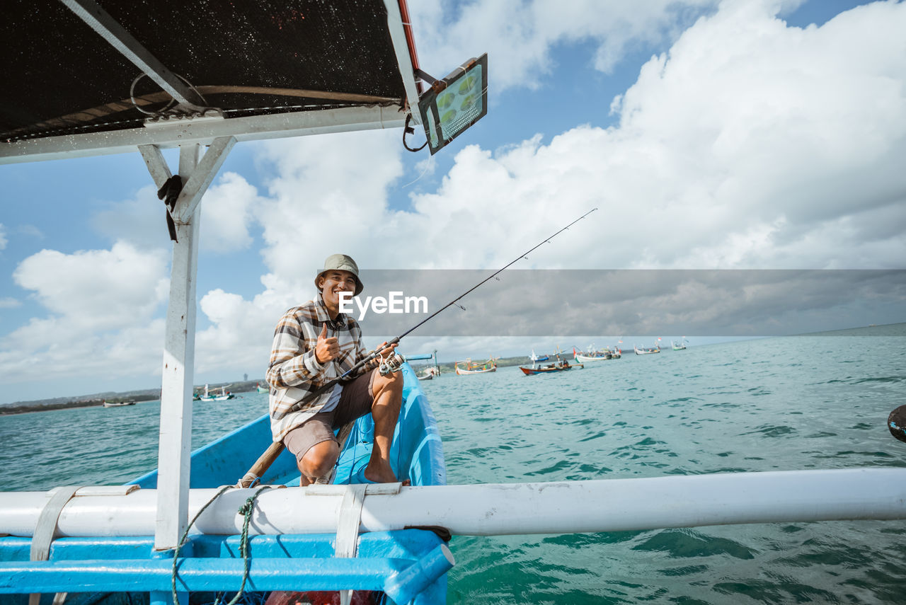 low angle view of man standing in sea