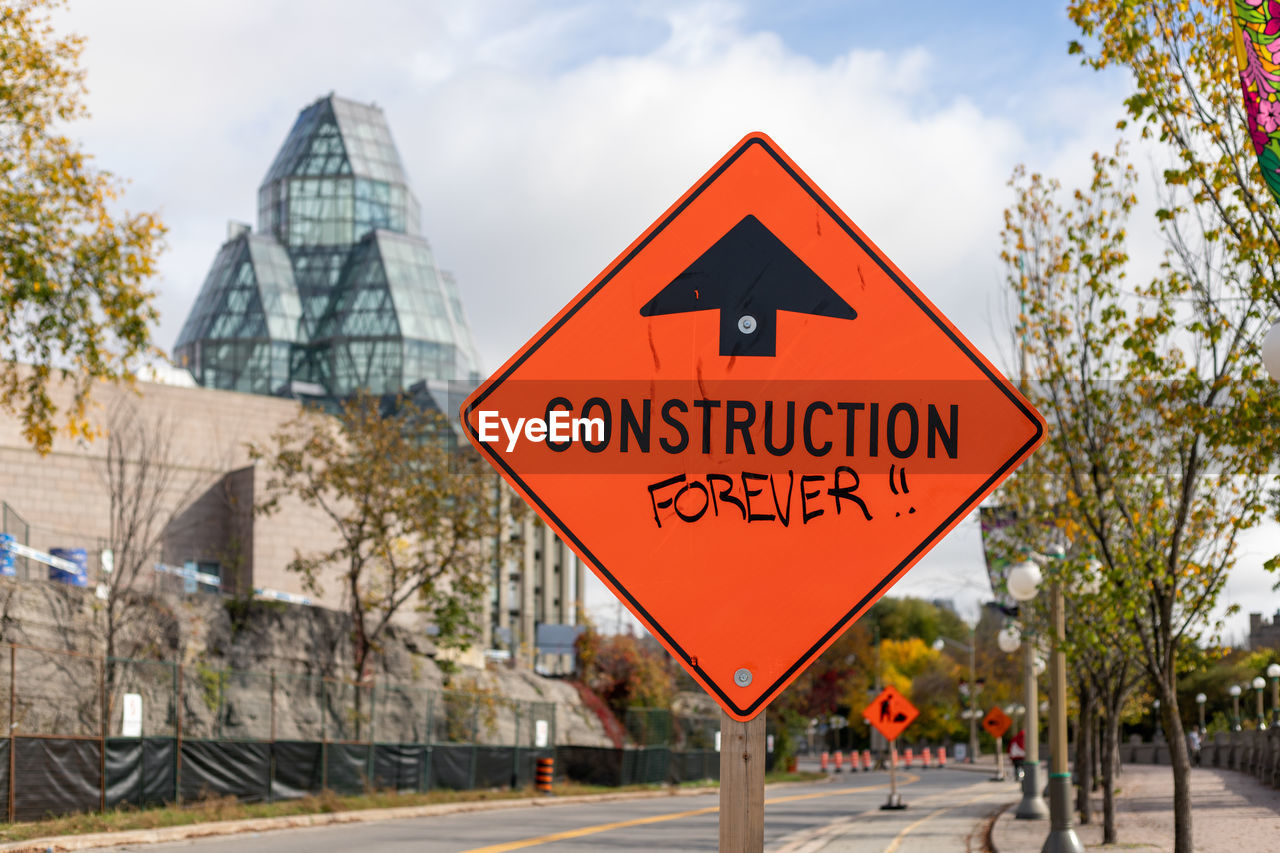 Warning construction ahead orange road sign in downtown of ottawa, canada