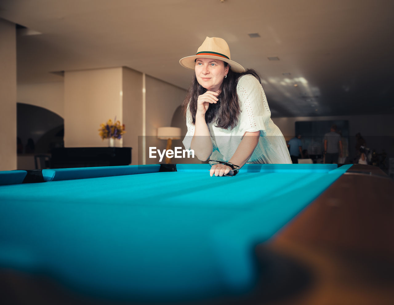 Portrait of young woman playing pool