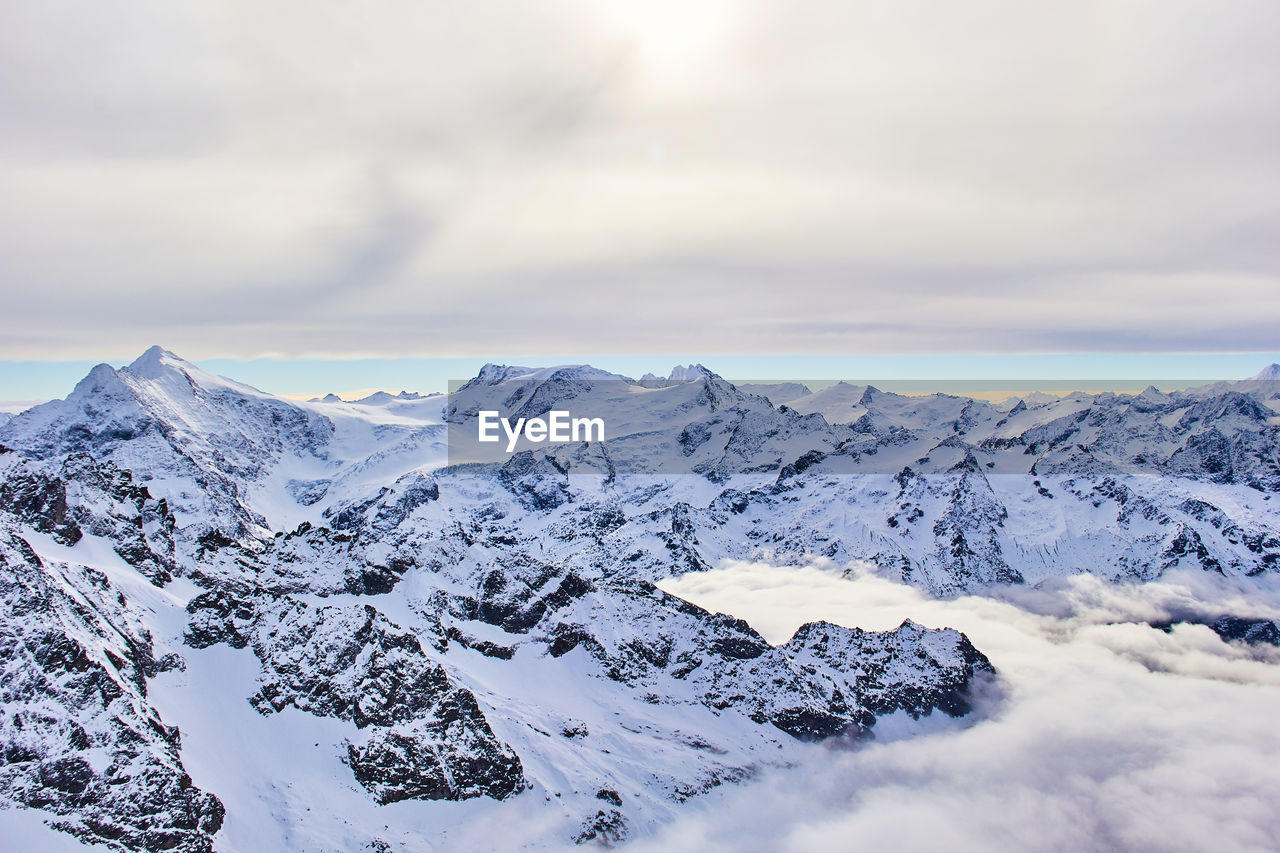 Scenic view of snow covered mountains against sky