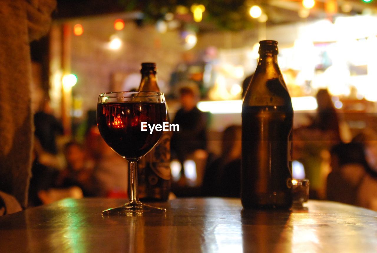 Wineglass with bottle on table at cafe