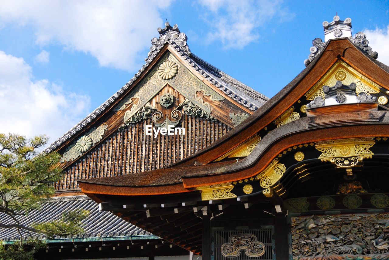 Low angle view of nijo castle against blue sky