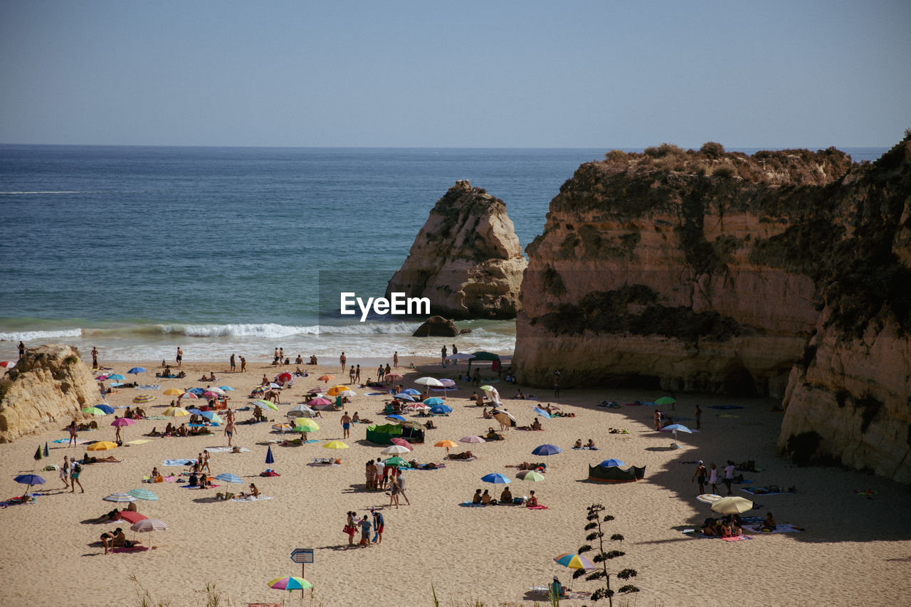 Scenic view of sea against clear sky on beach in portugal. 