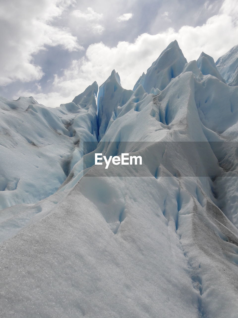 Scenic view of snow covered mountains against sky