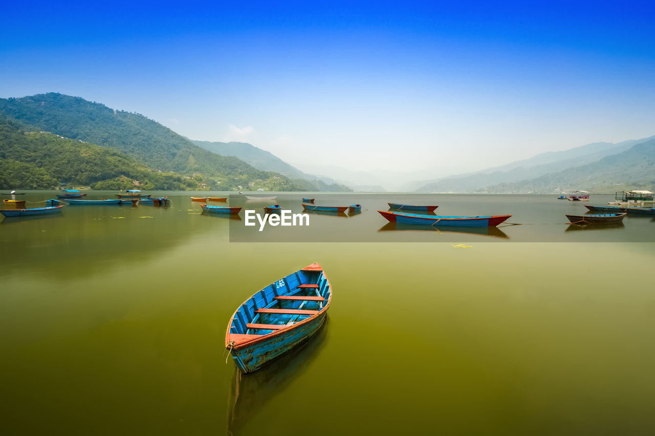 VIEW OF BOAT MOORED IN LAKE AGAINST SKY