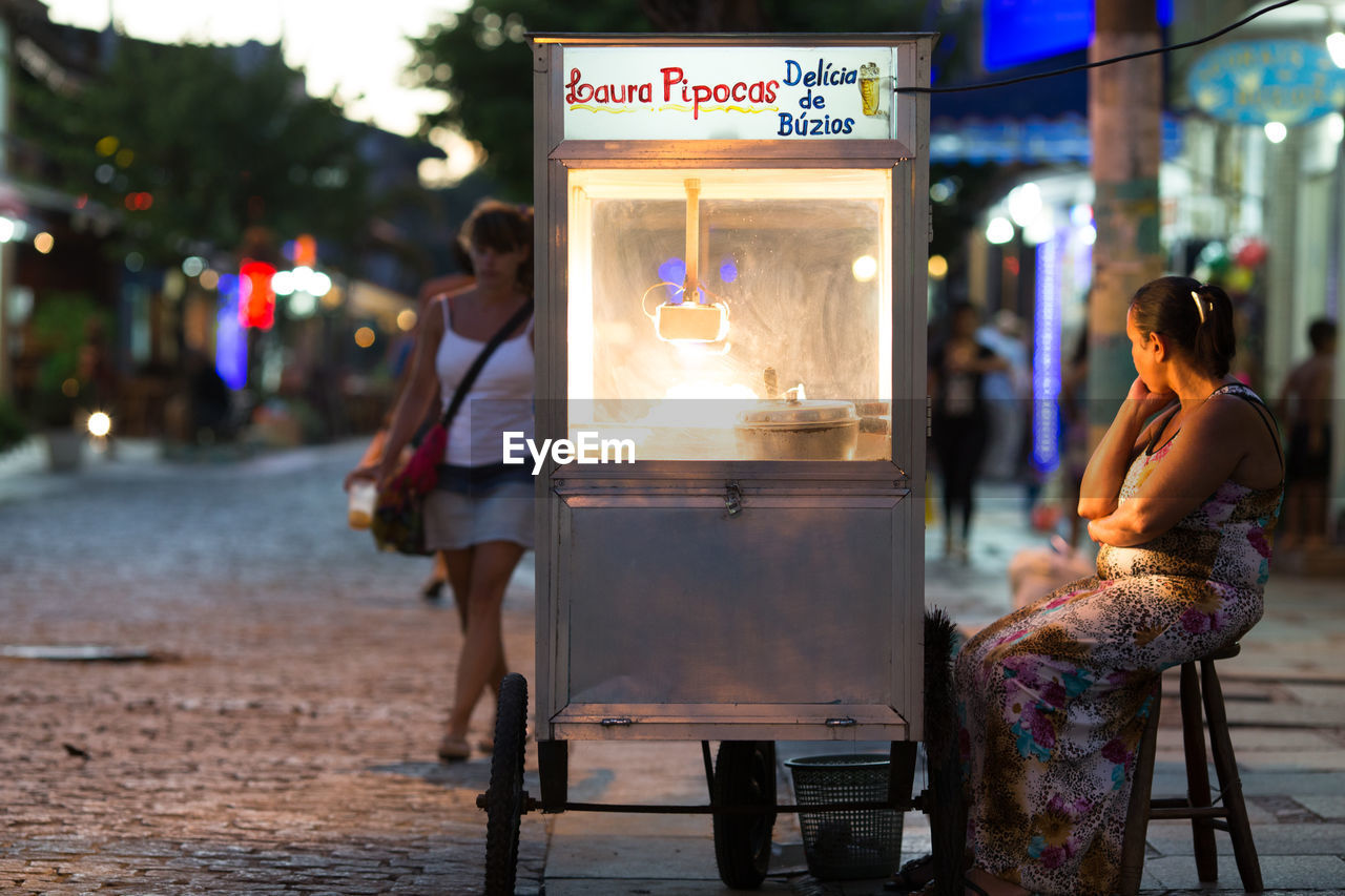 PEOPLE ON STREET AT NIGHT