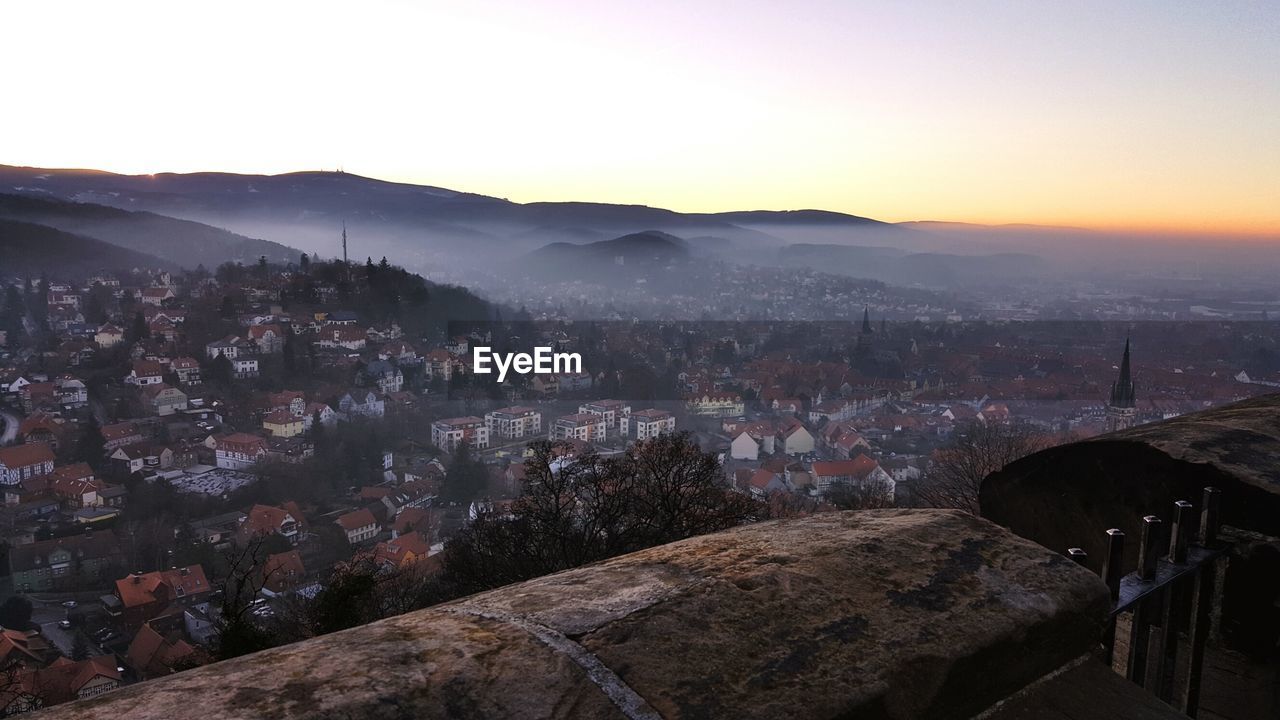 Aerial view of cityscape against sky during sunset